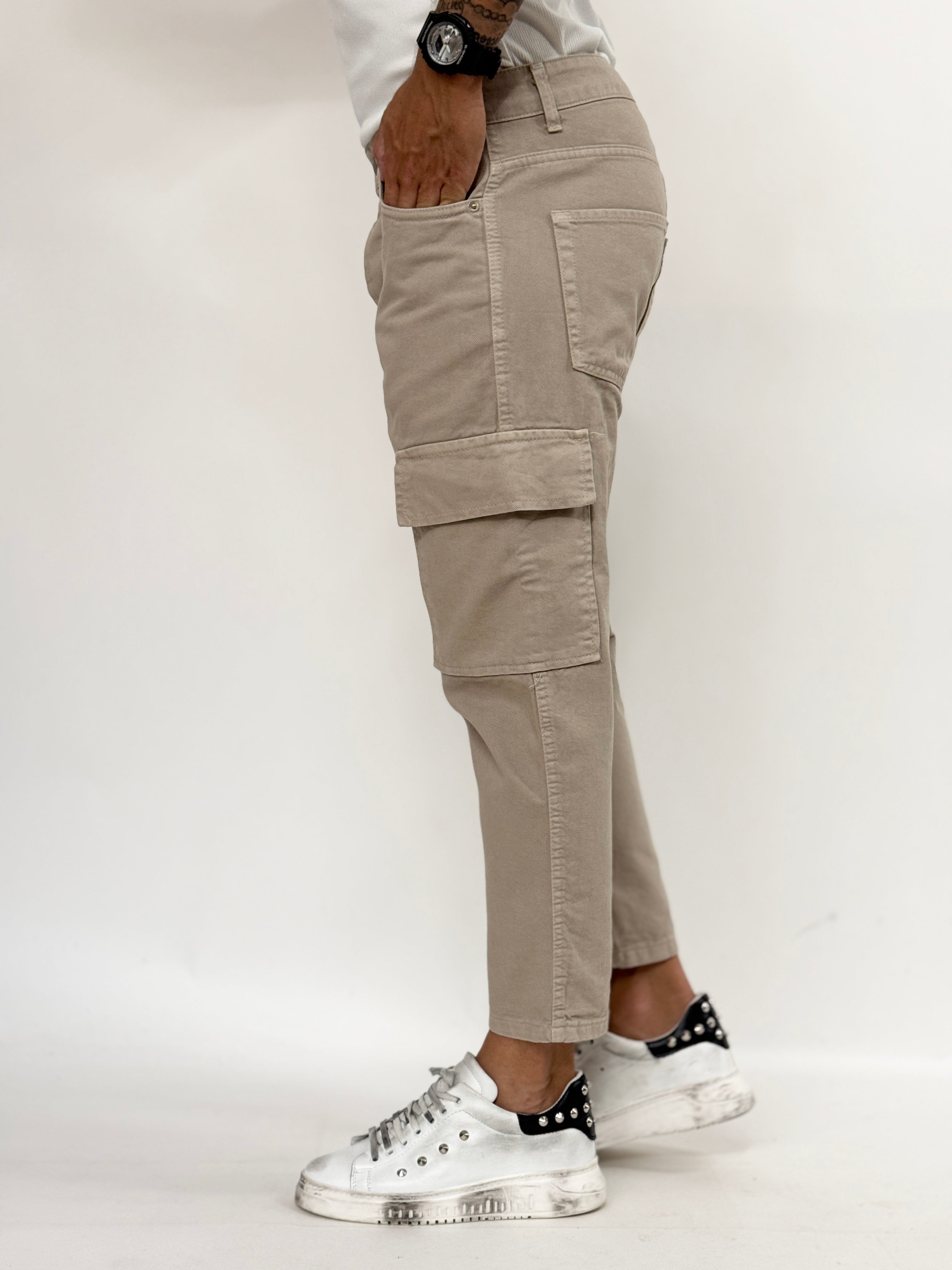 Beige carrot fit cargo jeans for men by Malkutha Store, featuring pockets and a relaxed silhouette.