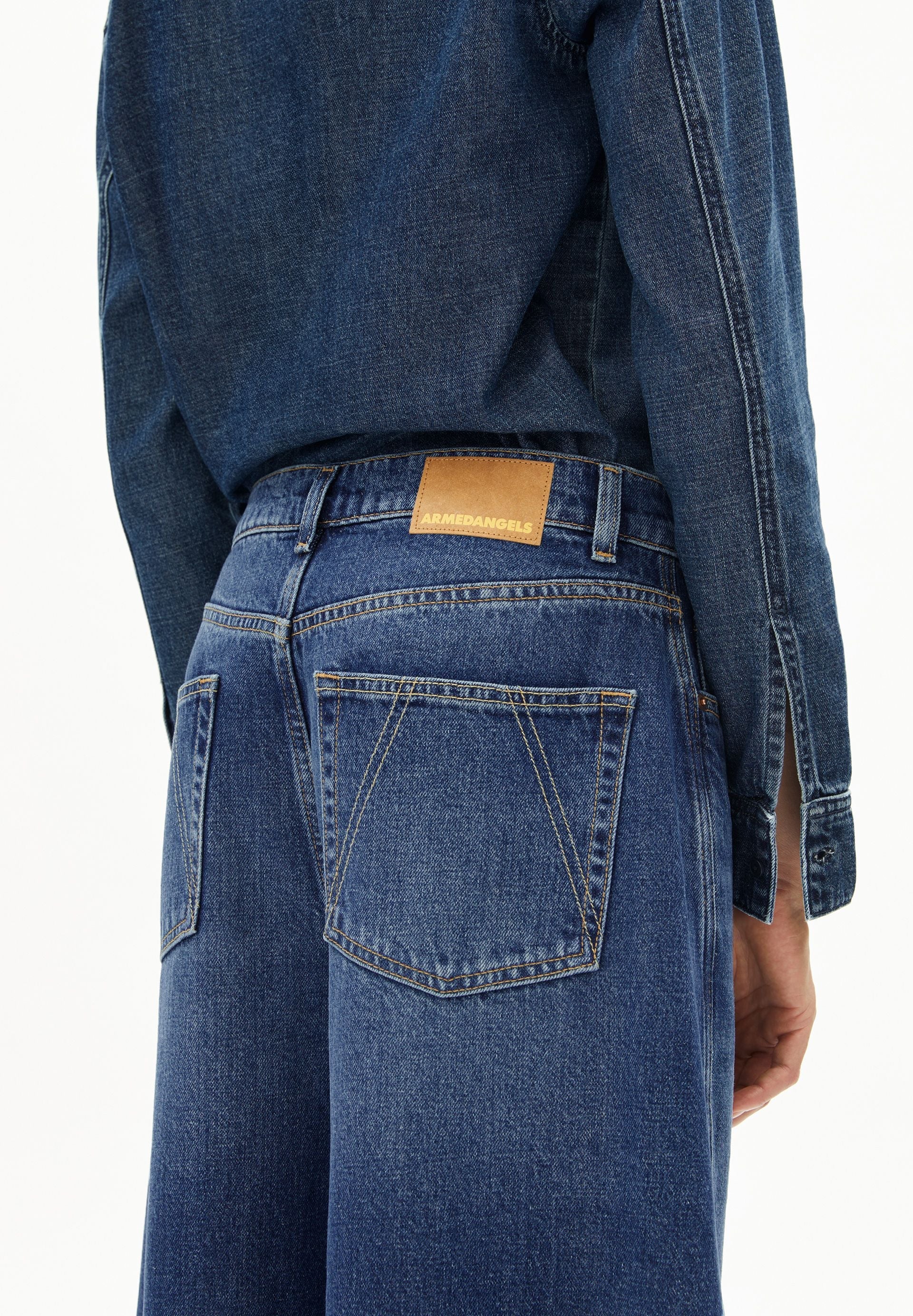 Mid waist barrel jeans by ARMEDANGELS in a faded wash, featuring five-pocket design and relaxed fit.