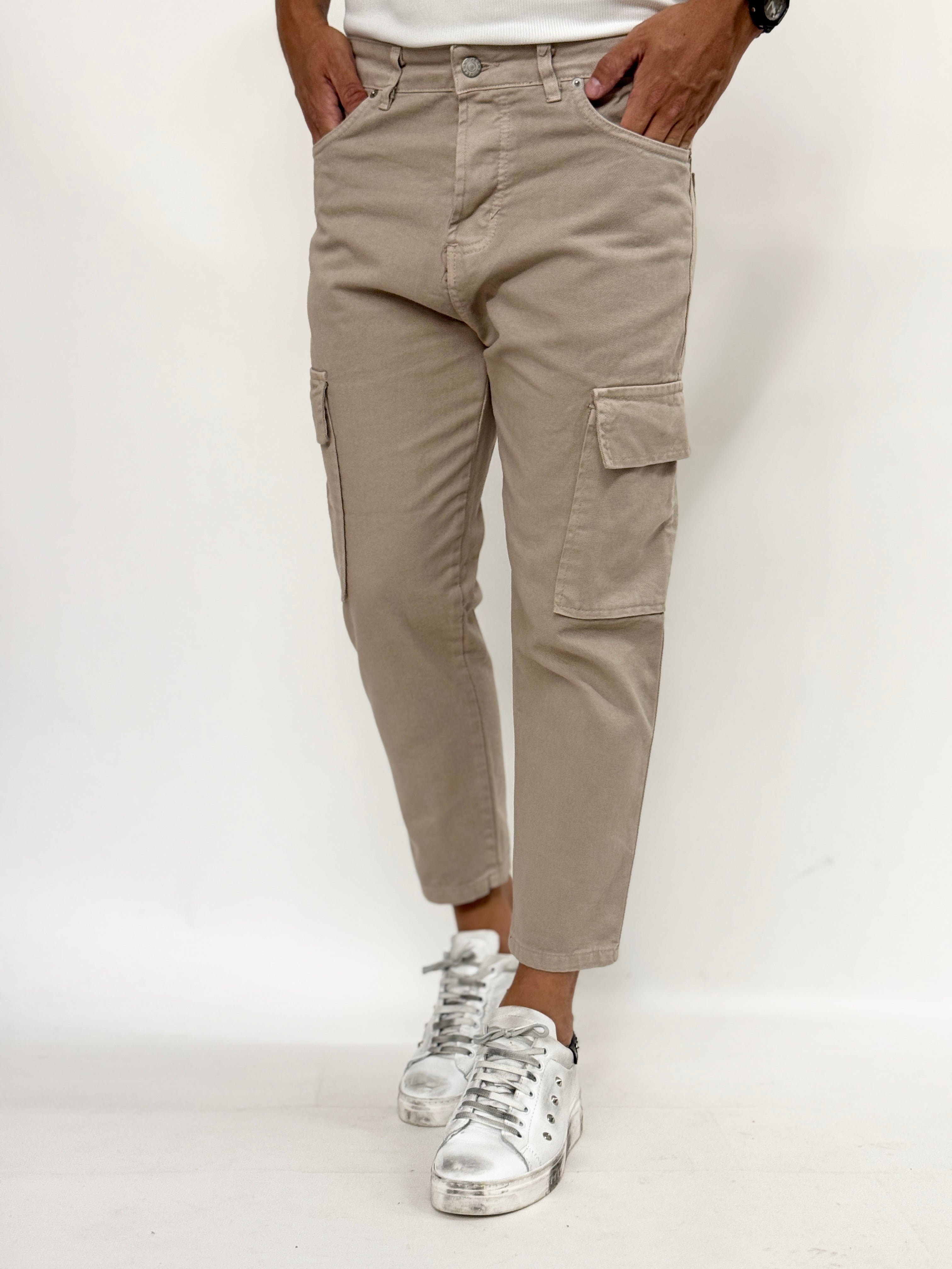 Beige carrot fit cargo jeans for men from Malkutha Store, showcasing pockets and a relaxed silhouette.