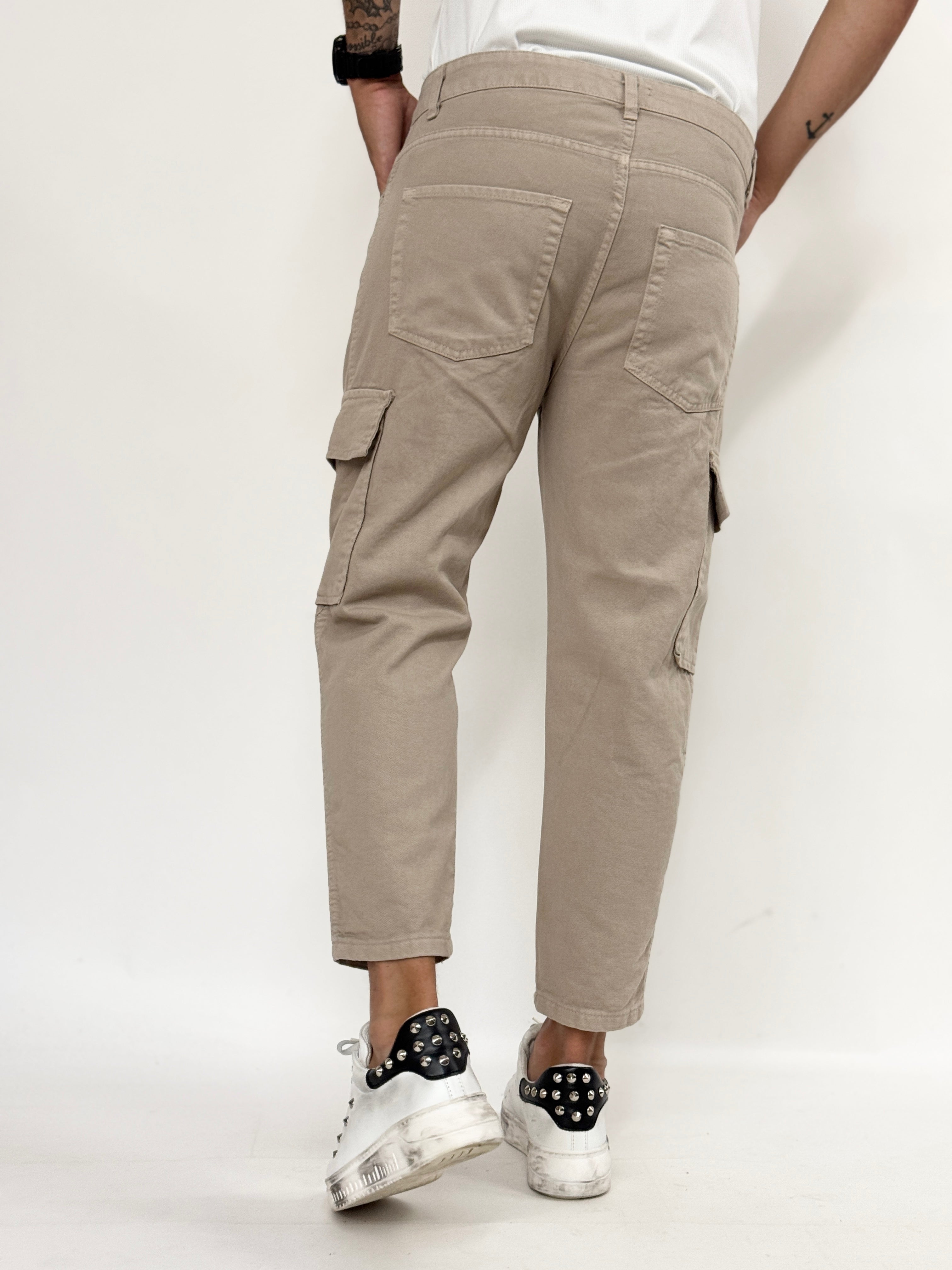 Beige carrot fit cargo jeans for men by Malkutha Store, featuring multiple pockets and a relaxed fit.
