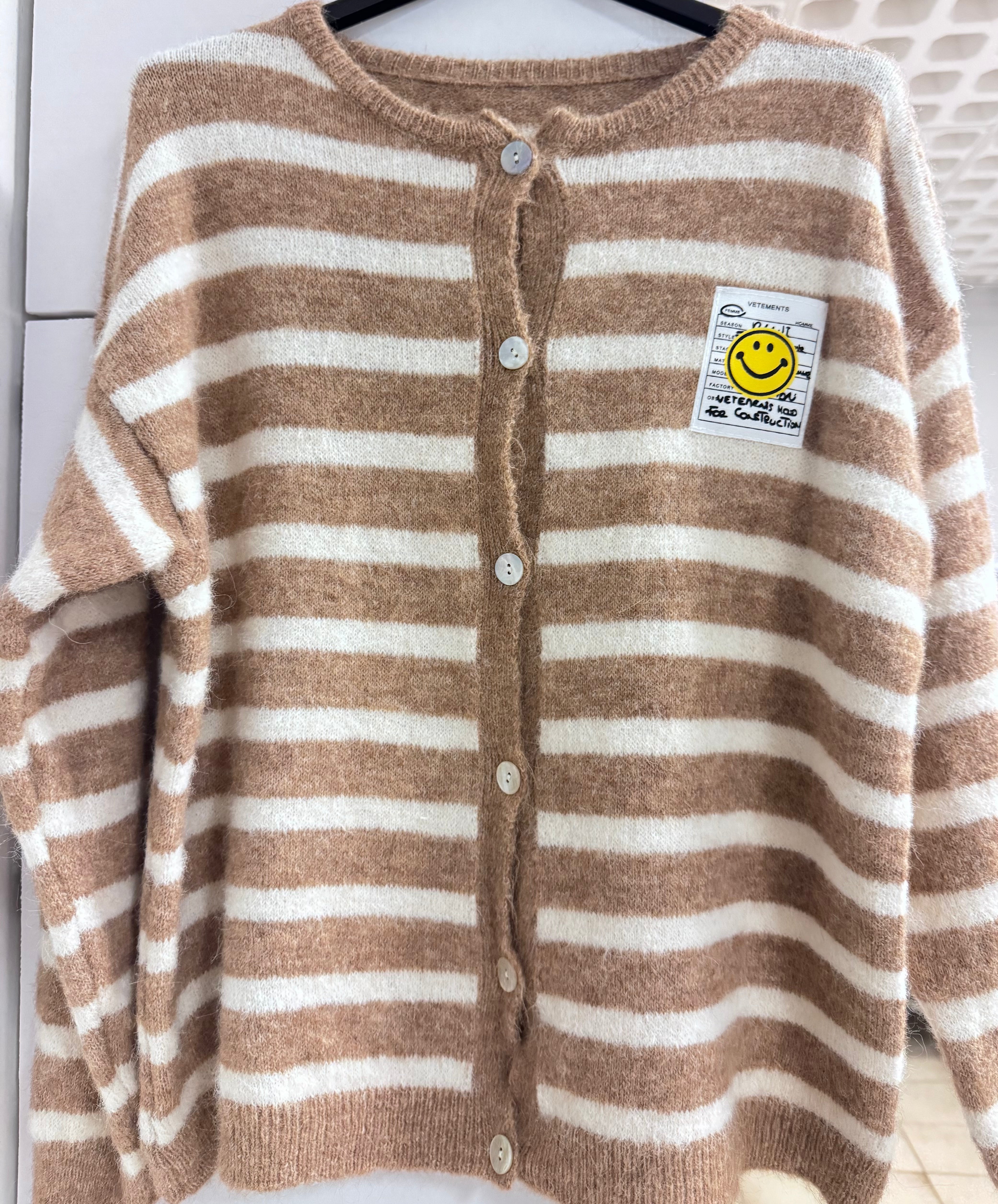 Gestreifter Cardigan "Smiley" by von Herzen featuring colorful stripes and a playful smiley face design.