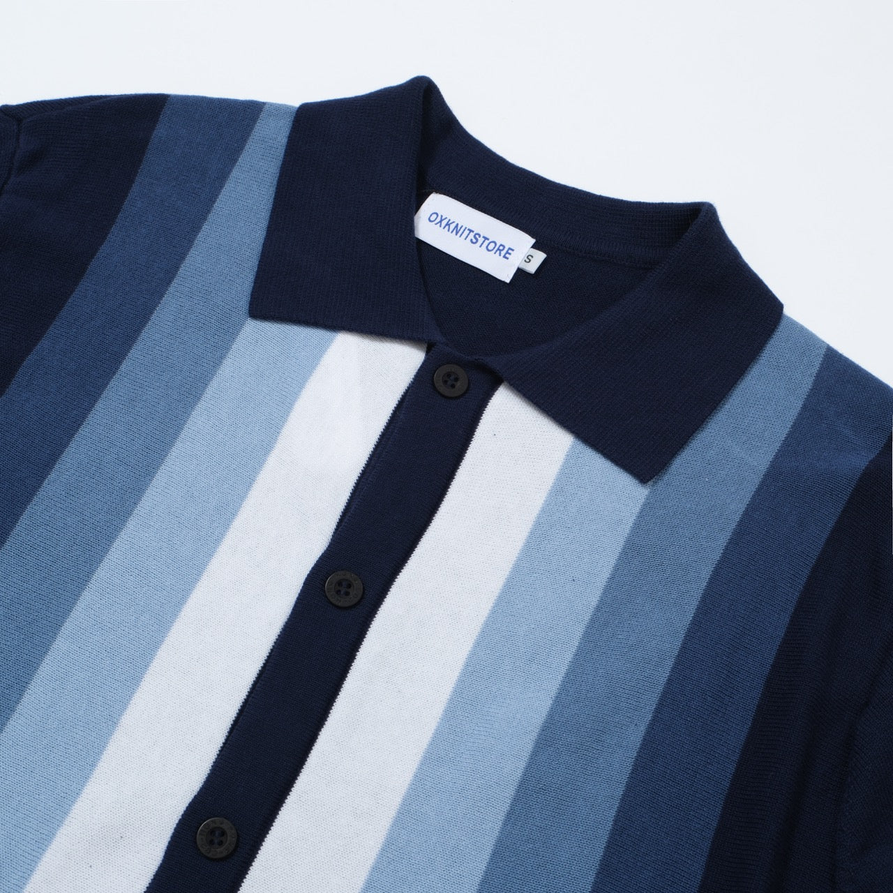 Men's OXKNIT vertical stripe knit polo shirt in navy and sky blue, featuring a classic button-up design.