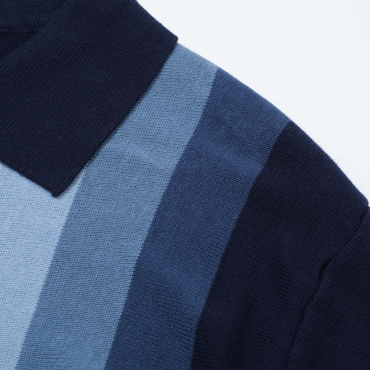 Men's OXKNIT 60s vertical stripe knit polo shirt in navy and sky blue with button-up design. Retro casual style.