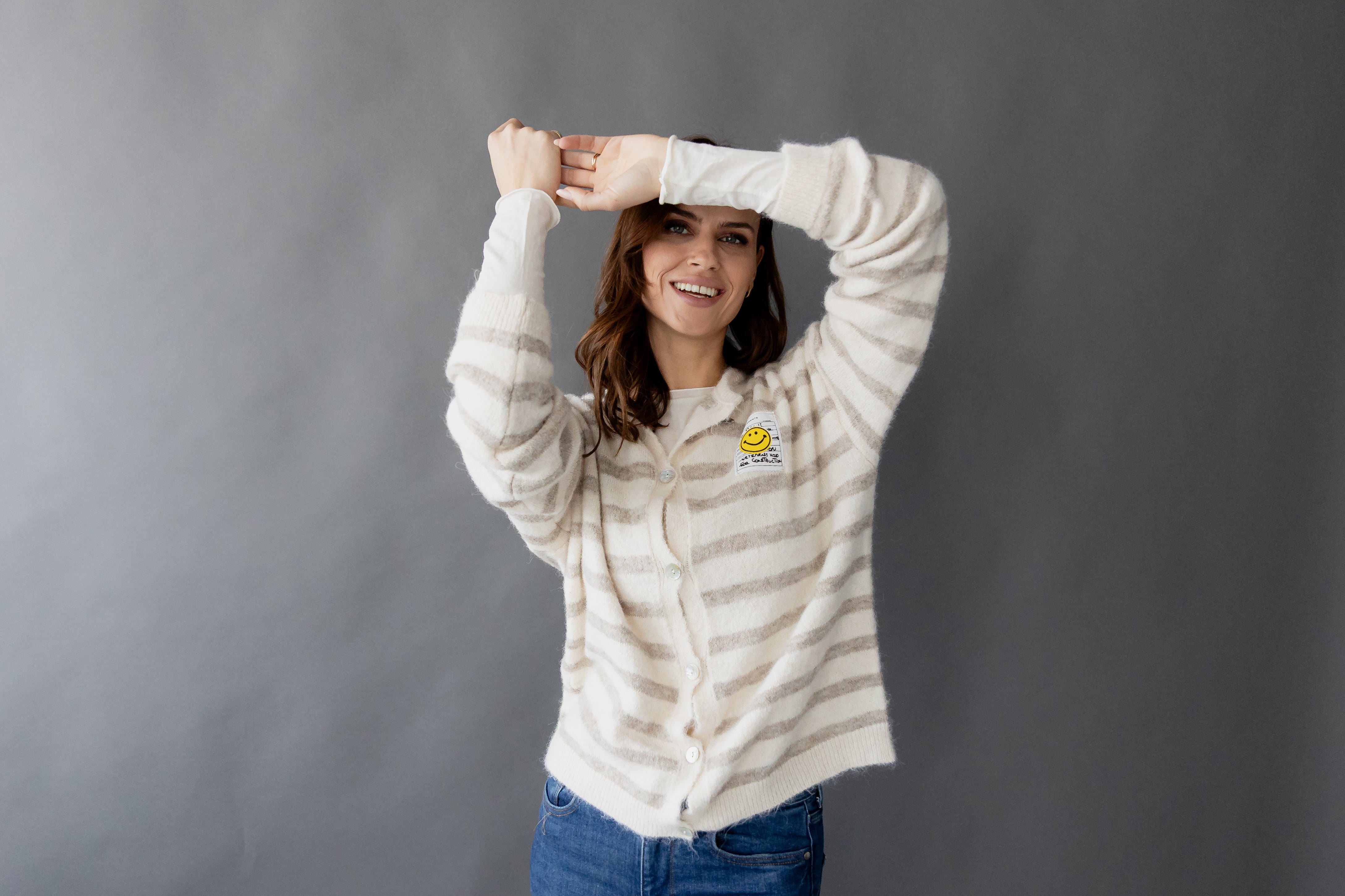 Gestreifter Cardigan "Smiley" by von Herzen, featuring a colorful striped design and cheerful smiley face detail.